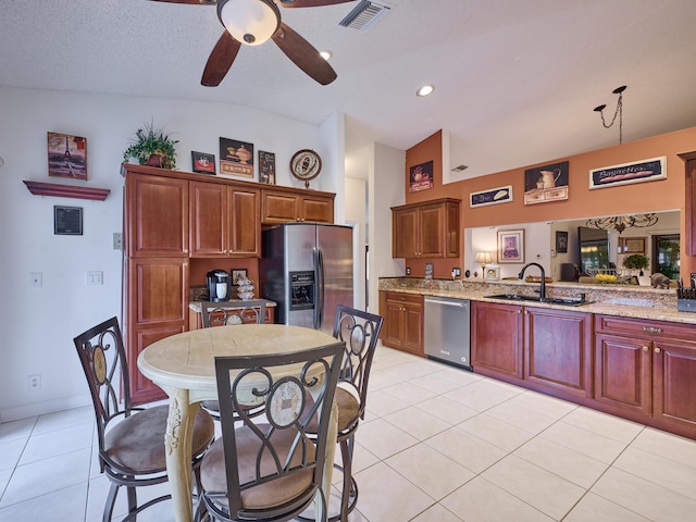 kitchen with light tile patterned floors, visible vents, appliances with stainless steel finishes, a sink, and a peninsula