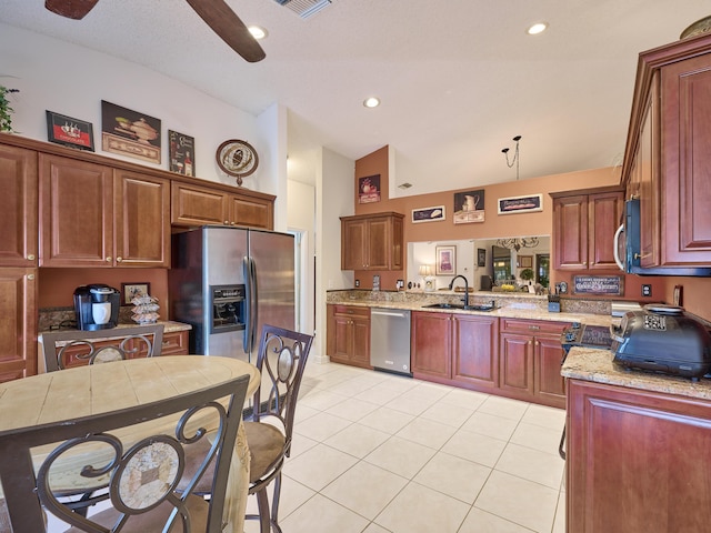 kitchen featuring light tile patterned flooring, stainless steel appliances, a peninsula, a sink, and pendant lighting