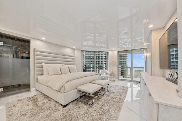 bedroom with marble finish floor, access to outside, and recessed lighting