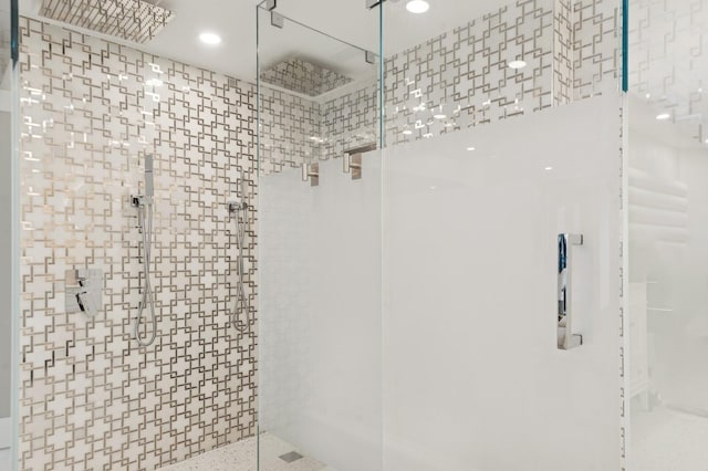 bathroom with a stall shower and recessed lighting