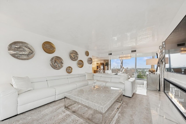 living room featuring expansive windows, marble finish floor, and visible vents