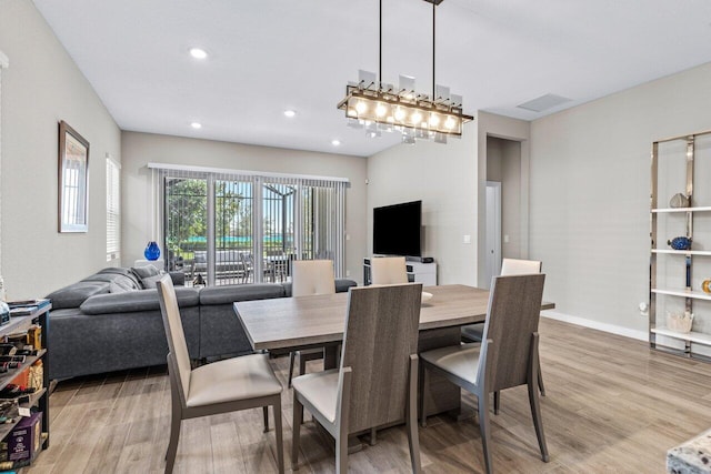 dining room featuring recessed lighting, baseboards, visible vents, and light wood finished floors