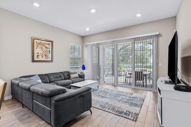 living area with recessed lighting and light wood-style floors