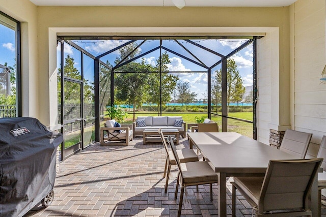 interior space featuring outdoor dining area, outdoor lounge area, a lanai, and a grill