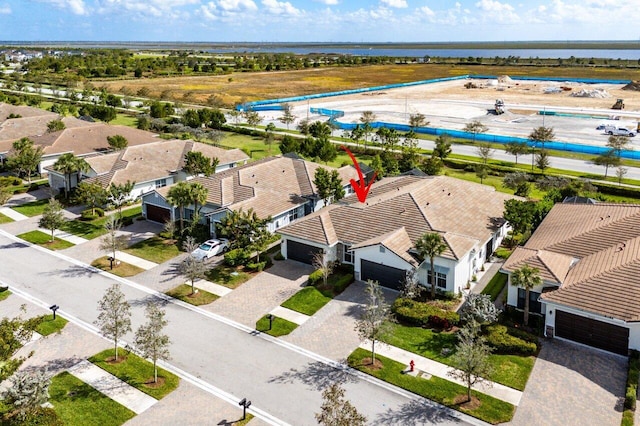 birds eye view of property with a water view and a residential view