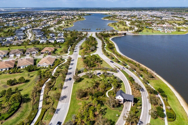 drone / aerial view with a water view and a residential view