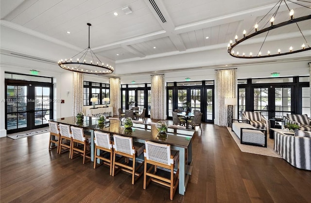 dining space with french doors, wood finished floors, beam ceiling, and a notable chandelier