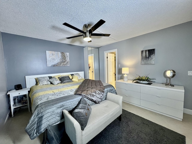 172 Tilford I, Deerfield Beach, FL 33442 - bedroom with light tile patterned flooring, a textured ceiling, and a ceiling fan