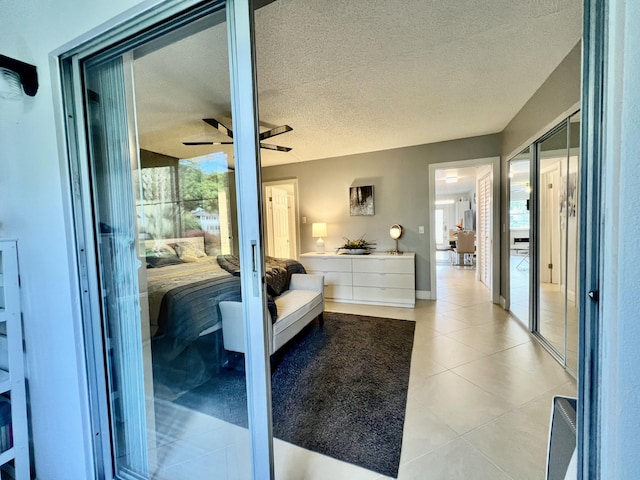 172 Tilford I, Deerfield Beach, FL 33442 - bedroom with light tile patterned floors, a textured ceiling, and a ceiling fan