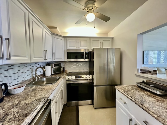 172 Tilford I, Deerfield Beach, FL 33442 - kitchen with dark stone countertops, ceiling fan, a sink, appliances with stainless steel finishes, and backsplash