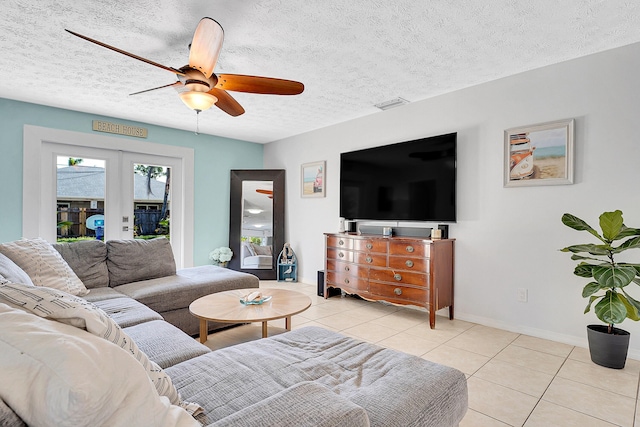 living area featuring light tile patterned floors, baseboards, visible vents, a textured ceiling, and french doors