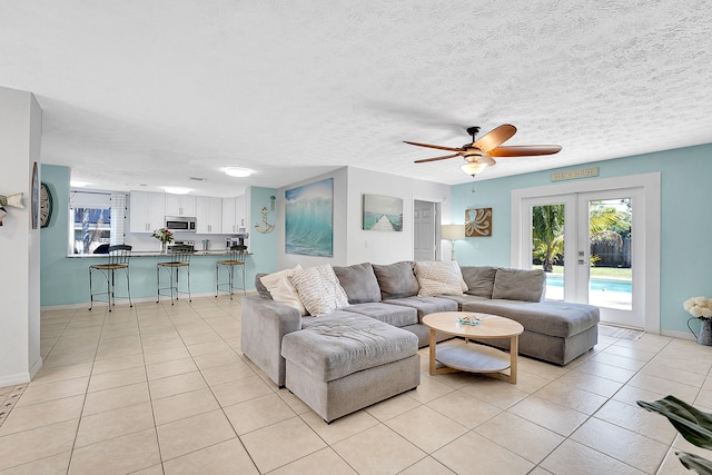 living room with french doors, a healthy amount of sunlight, and light tile patterned floors