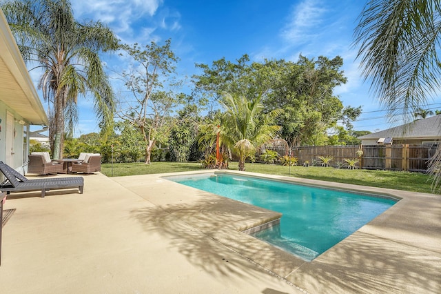 view of pool featuring a fenced backyard, an outdoor living space, a lawn, a fenced in pool, and a patio area