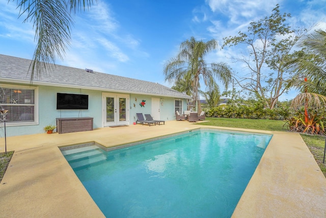 outdoor pool with french doors, a patio, and an outdoor living space