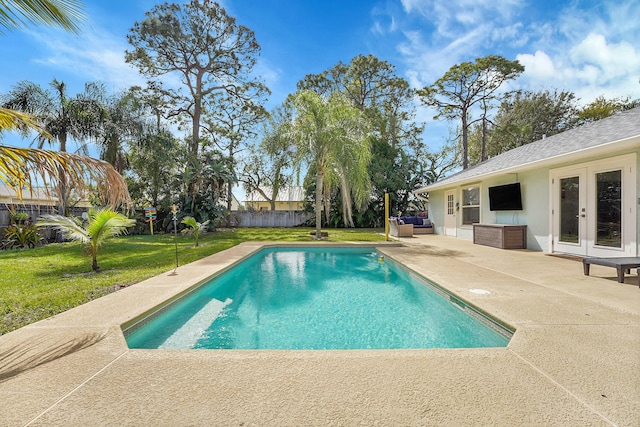 view of swimming pool featuring a fenced in pool, french doors, a patio, a lawn, and a fenced backyard