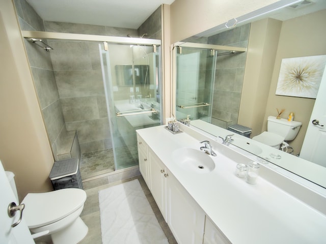 full bathroom with toilet, a shower stall, and vanity