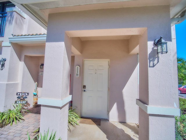 doorway to property with stucco siding