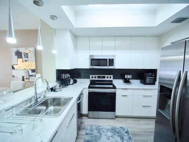 kitchen with appliances with stainless steel finishes, modern cabinets, and white cabinets