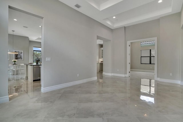 spare room with visible vents, a high ceiling, baseboards, and recessed lighting