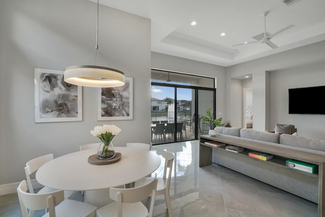 dining room with baseboards, visible vents, a ceiling fan, a tray ceiling, and recessed lighting