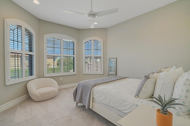 carpeted bedroom with multiple windows, recessed lighting, and baseboards