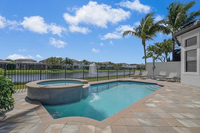 view of swimming pool with a residential view, a pool with connected hot tub, fence, and a patio