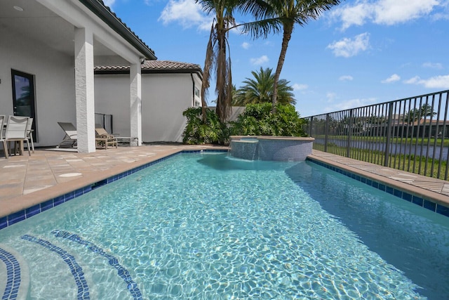 view of pool featuring a patio, fence, and a pool with connected hot tub