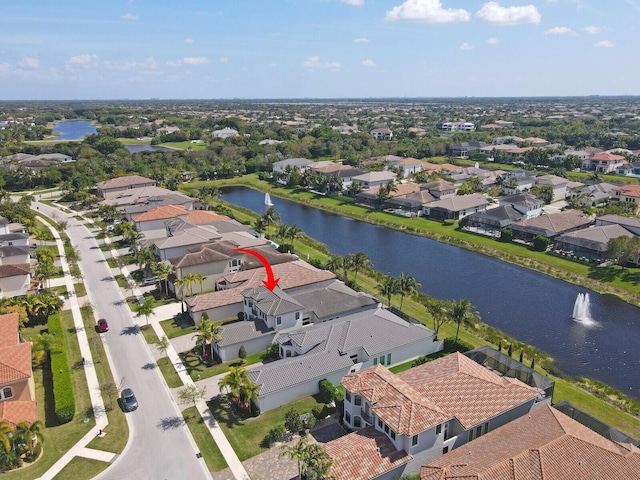 birds eye view of property with a residential view and a water view