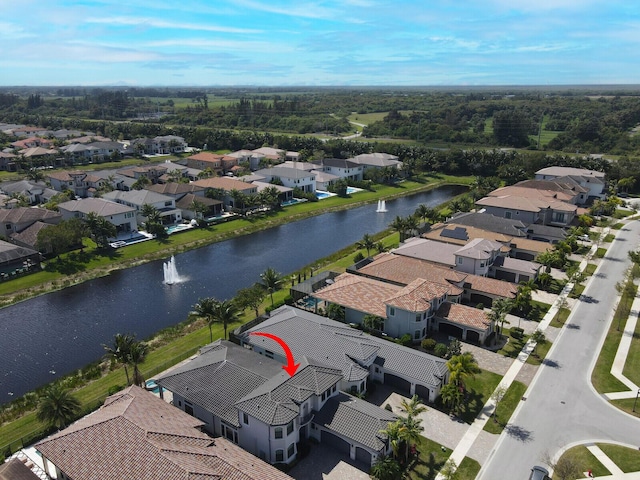 drone / aerial view with a water view and a residential view