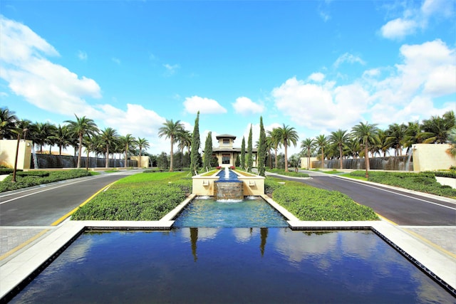 view of home's community featuring uncovered parking and a water view