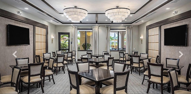 dining room featuring a chandelier, a tray ceiling, visible vents, and recessed lighting