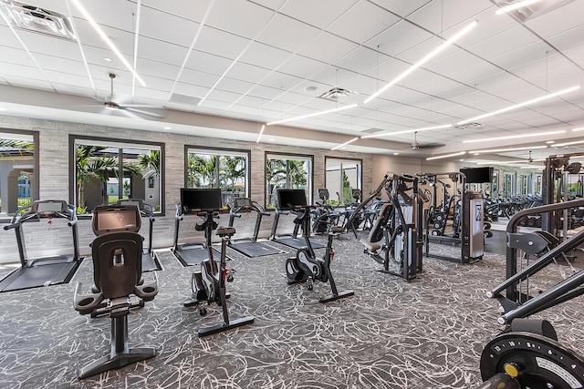 workout area with a paneled ceiling, carpet, and visible vents