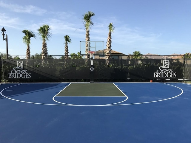 view of basketball court with community basketball court and fence