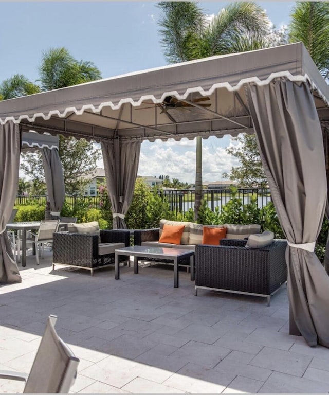 view of patio / terrace with fence, a gazebo, and an outdoor hangout area