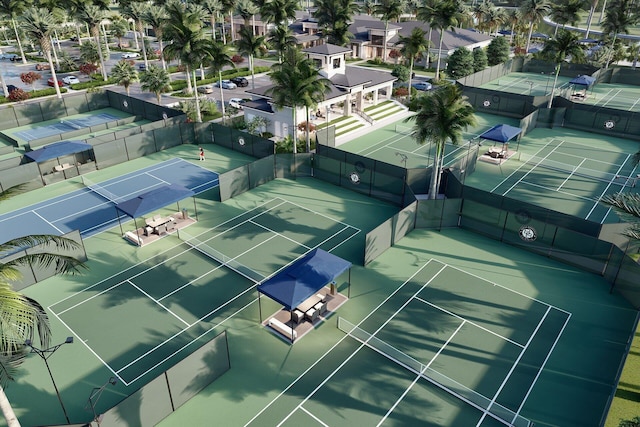 view of tennis court featuring a residential view and fence