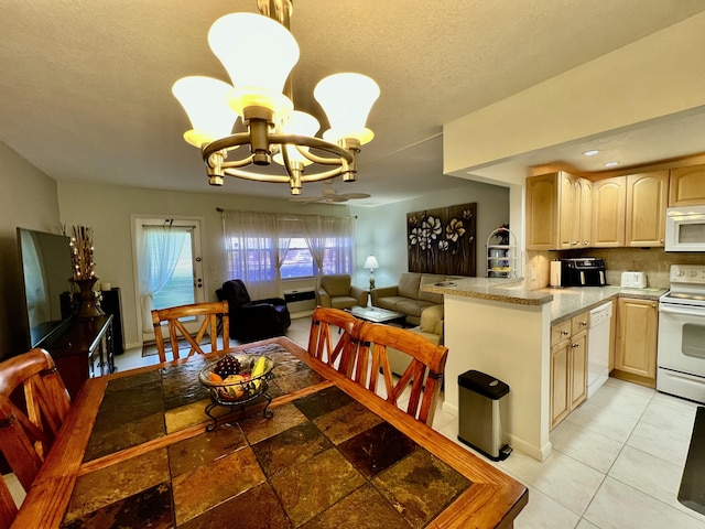 dining area featuring light tile patterned floors, a notable chandelier, and a textured ceiling