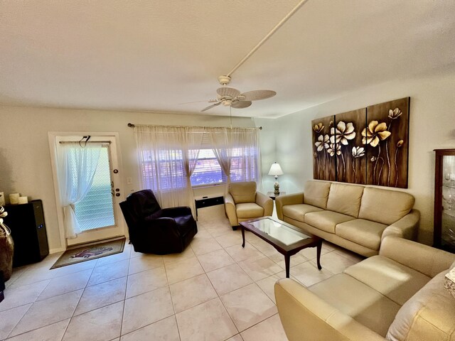 living area featuring light tile patterned flooring and ceiling fan