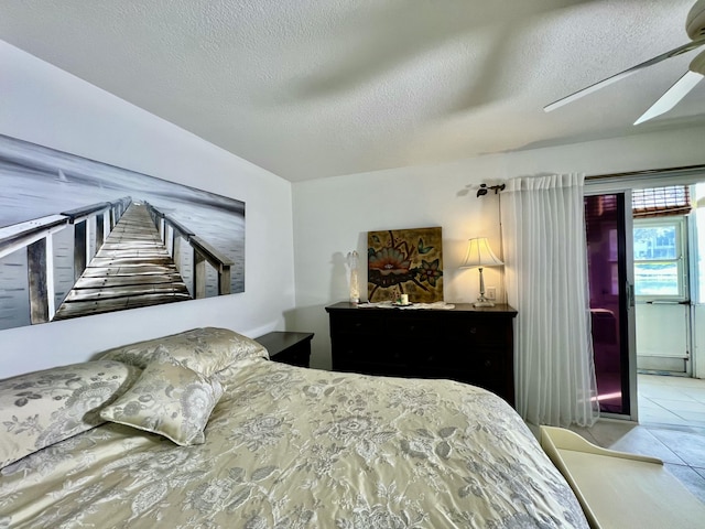 bedroom with tile patterned flooring, a textured ceiling, and ceiling fan