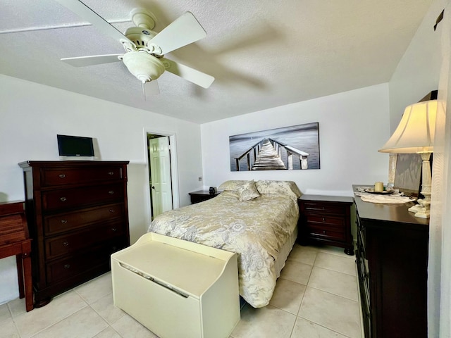 bedroom featuring light tile patterned floors, a textured ceiling, and a ceiling fan