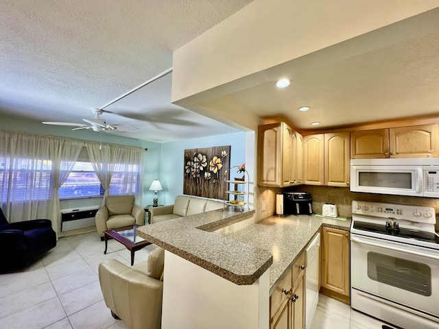 kitchen with tasteful backsplash, light brown cabinetry, open floor plan, light tile patterned floors, and white appliances