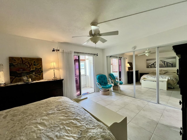 bedroom with light tile patterned floors, a textured ceiling, and ceiling fan