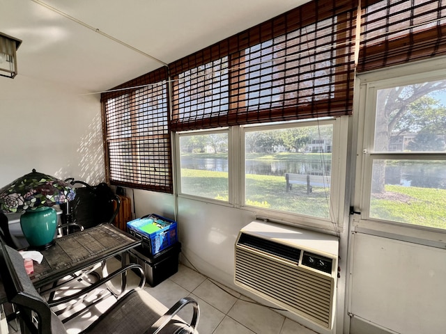 sunroom featuring a water view