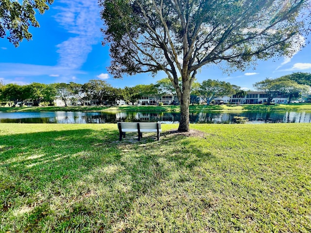 view of home's community featuring a yard and a water view