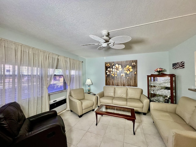 living room with light tile patterned floors, a textured ceiling, and ceiling fan