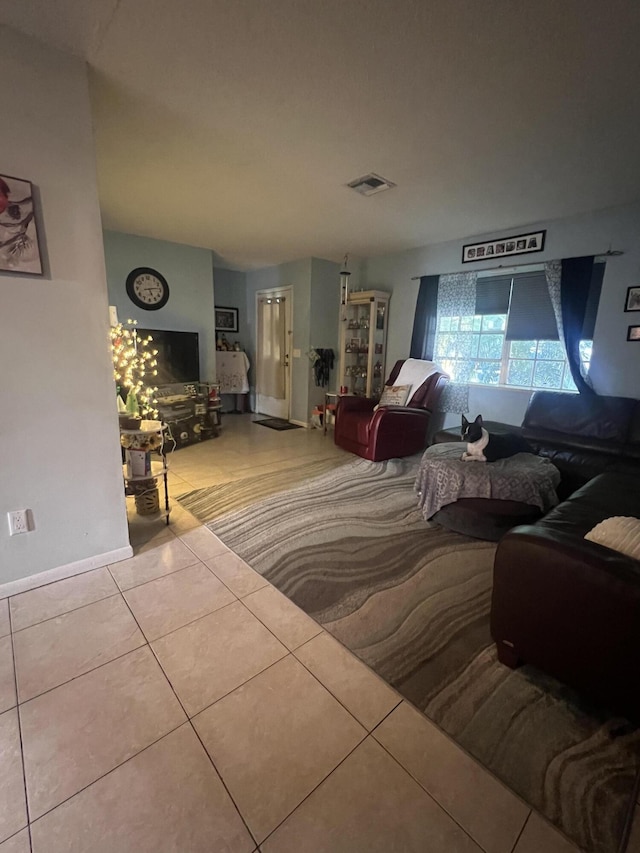 living room featuring visible vents, baseboards, and light tile patterned floors