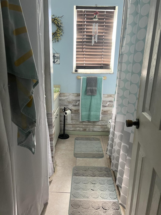 bathroom with vanity, wainscoting, and tile patterned flooring