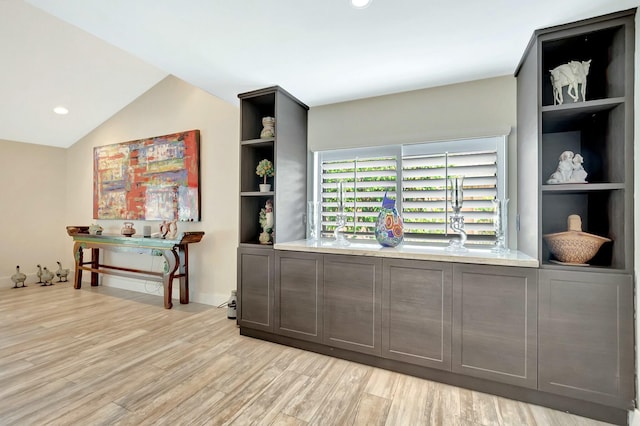 interior space featuring vaulted ceiling, recessed lighting, built in features, and light wood-style floors