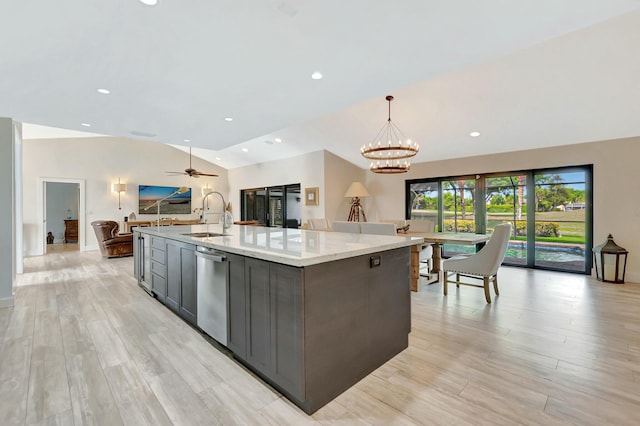 kitchen featuring open floor plan, stainless steel dishwasher, a spacious island, and a sink