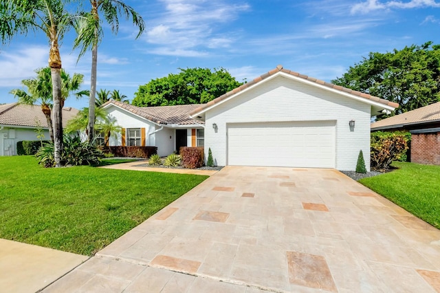 ranch-style home with an attached garage, a tiled roof, a front yard, and driveway