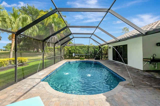 outdoor pool featuring a lanai and a patio area